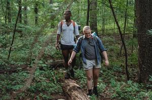 two adults hiking in the woods